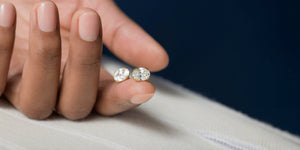 Melanie Casey Jewelry | Earring Collection | Hand holding 2ctw Oval Cut Threaded Studs 