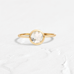 Edifice Ring Rose Cut Engagement Ring in Yellow Gold by Melanie Casey shown on a textured white background