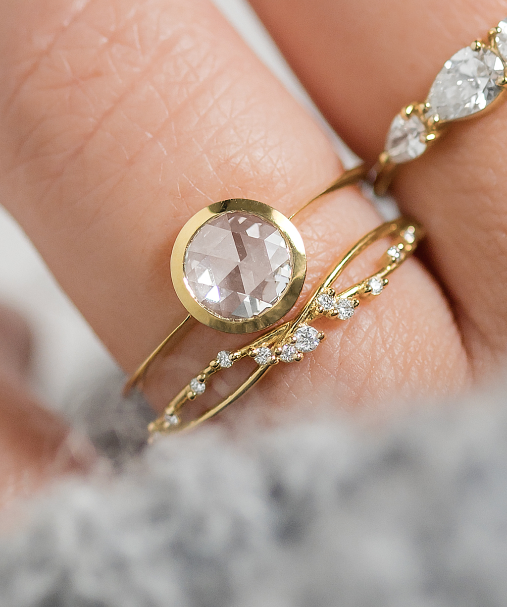 Photo features the Melanie Casey Edifice Bezel Ring worn on a model's hand.