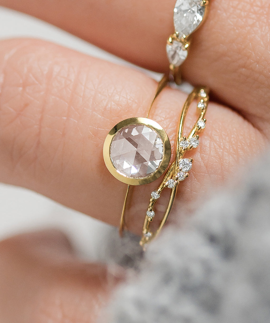 Photo features the Melanie Casey Edifice Bezel Ring worn on a model's hand.