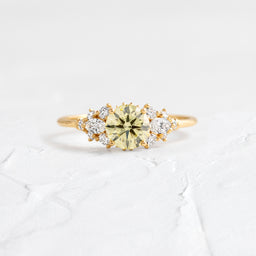 The Nebula Ring, 0.76ct. Natural Yellow Diamond shown on a textured white background.