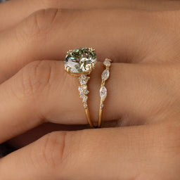 Photo features a model wearing a Melanie Casey Round Cut Green Diamond On the Horizon Engagement Ring.