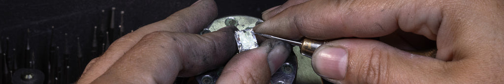 A Melanie Casey Engagement Ring being worked on by a jeweler at their bench.