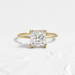 The Threaded Ring, 2.01ct. Natural Radiant Cut shown on a textured white background.